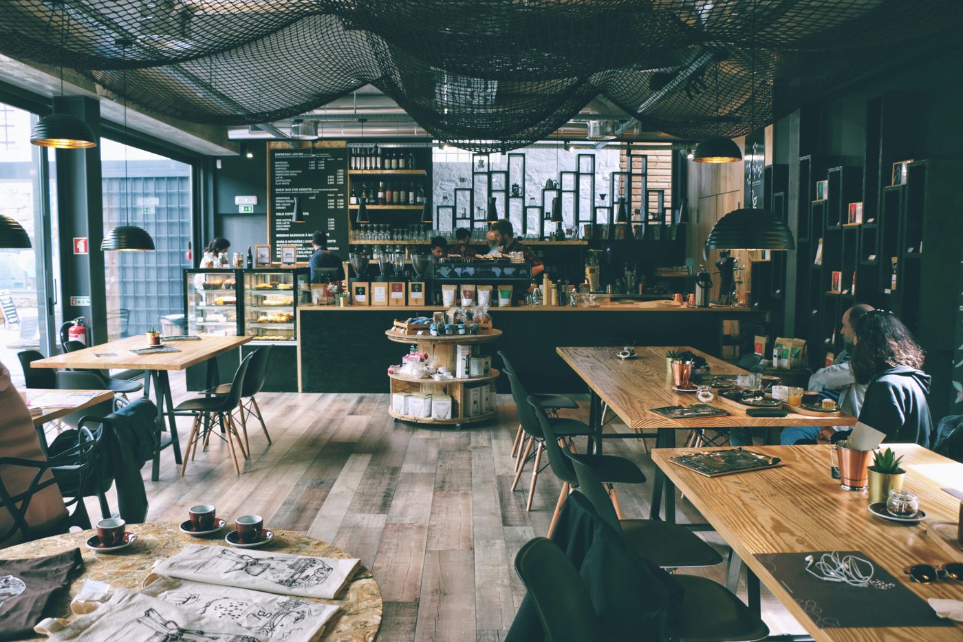The warm, wood-filled interior of Corner Table cafe with a coffee counter and seating